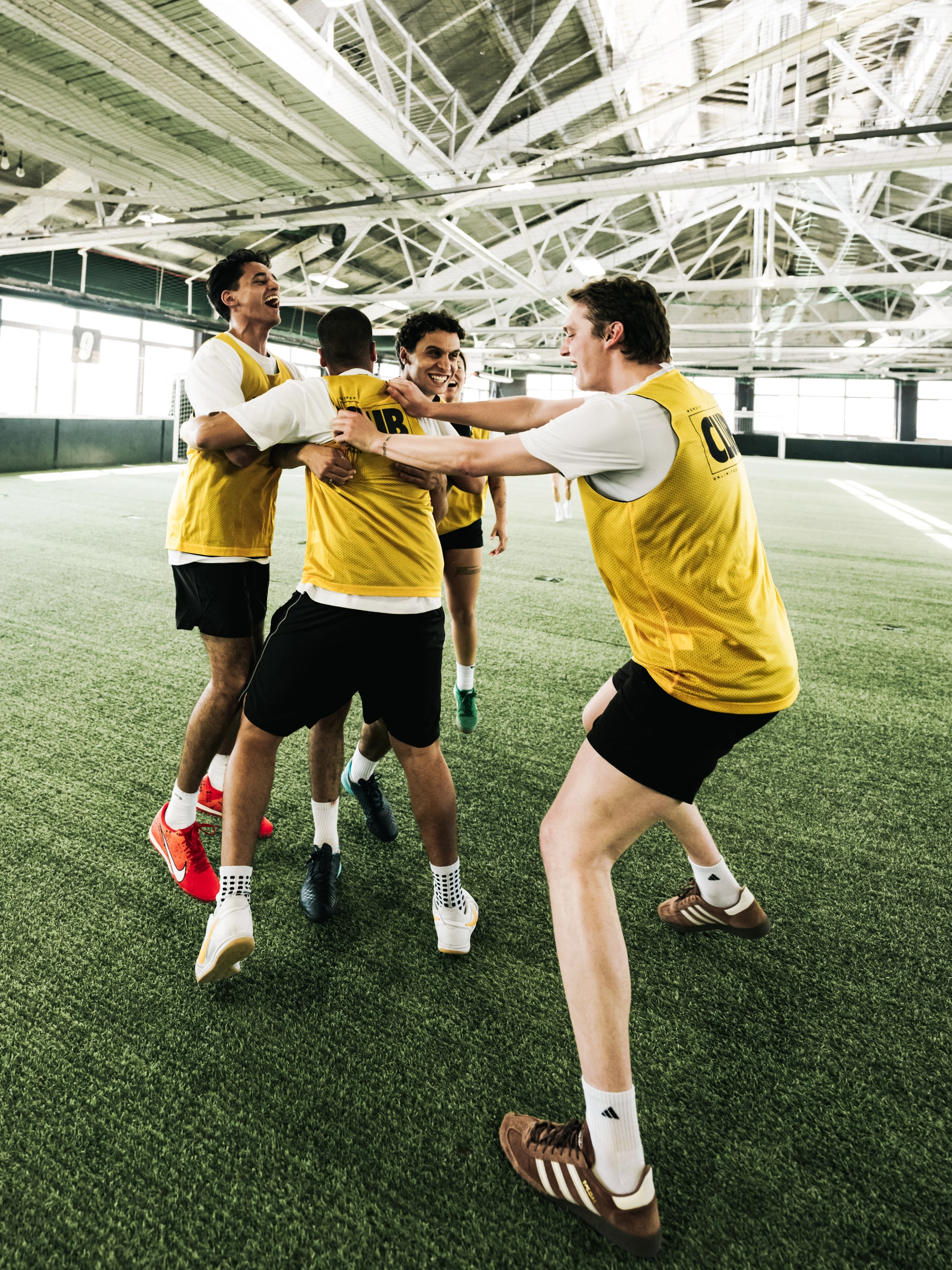 Players celebrating together on an indoor field.